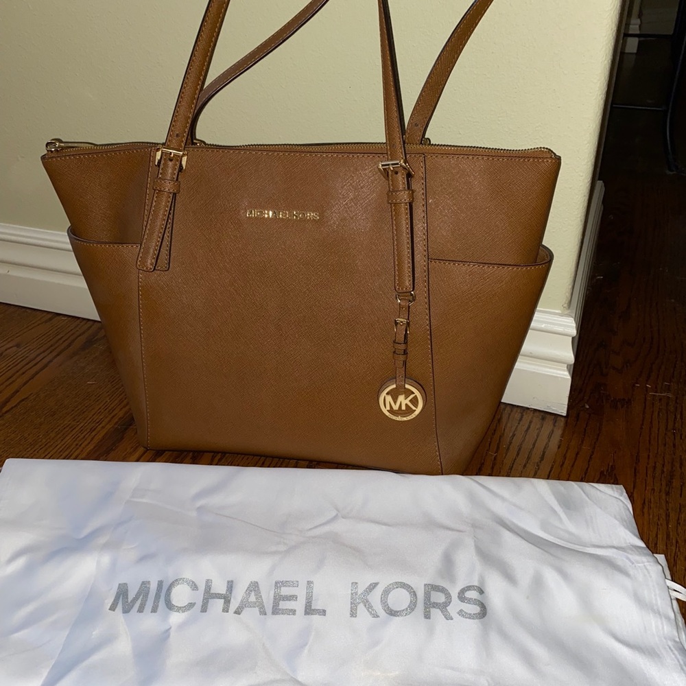Authentic Michael Kors leather bag with dust bag. Like new. Great gift.
